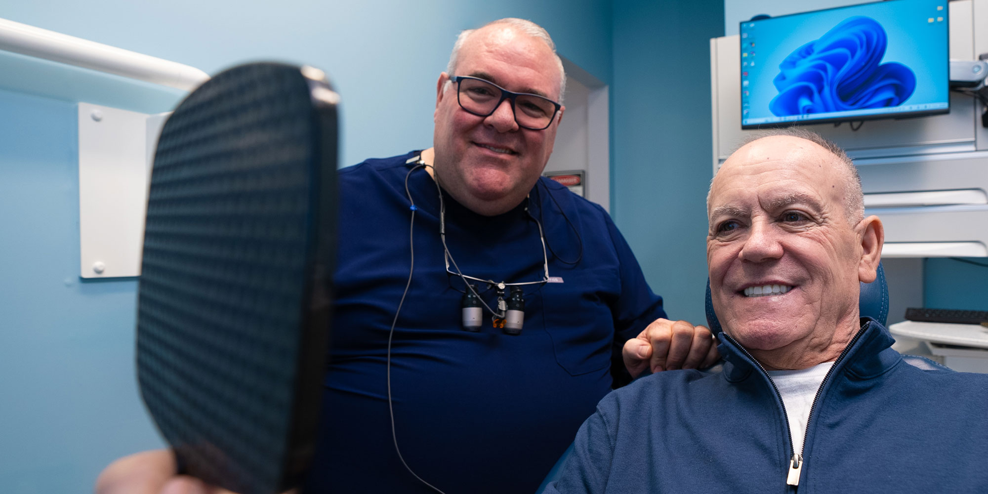 patient and doctor smiling together after patient treatment