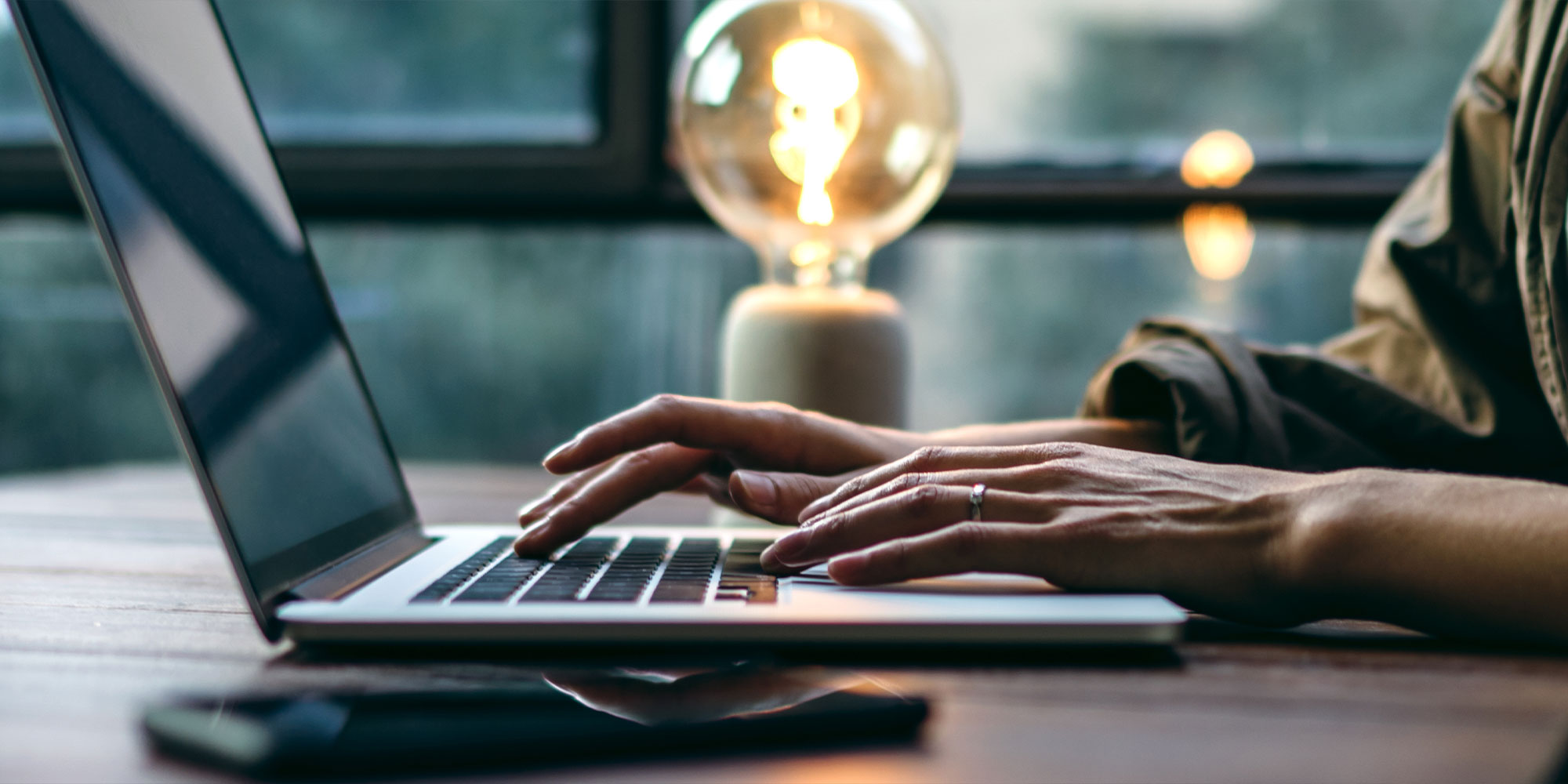 close up of person typing on a laptop