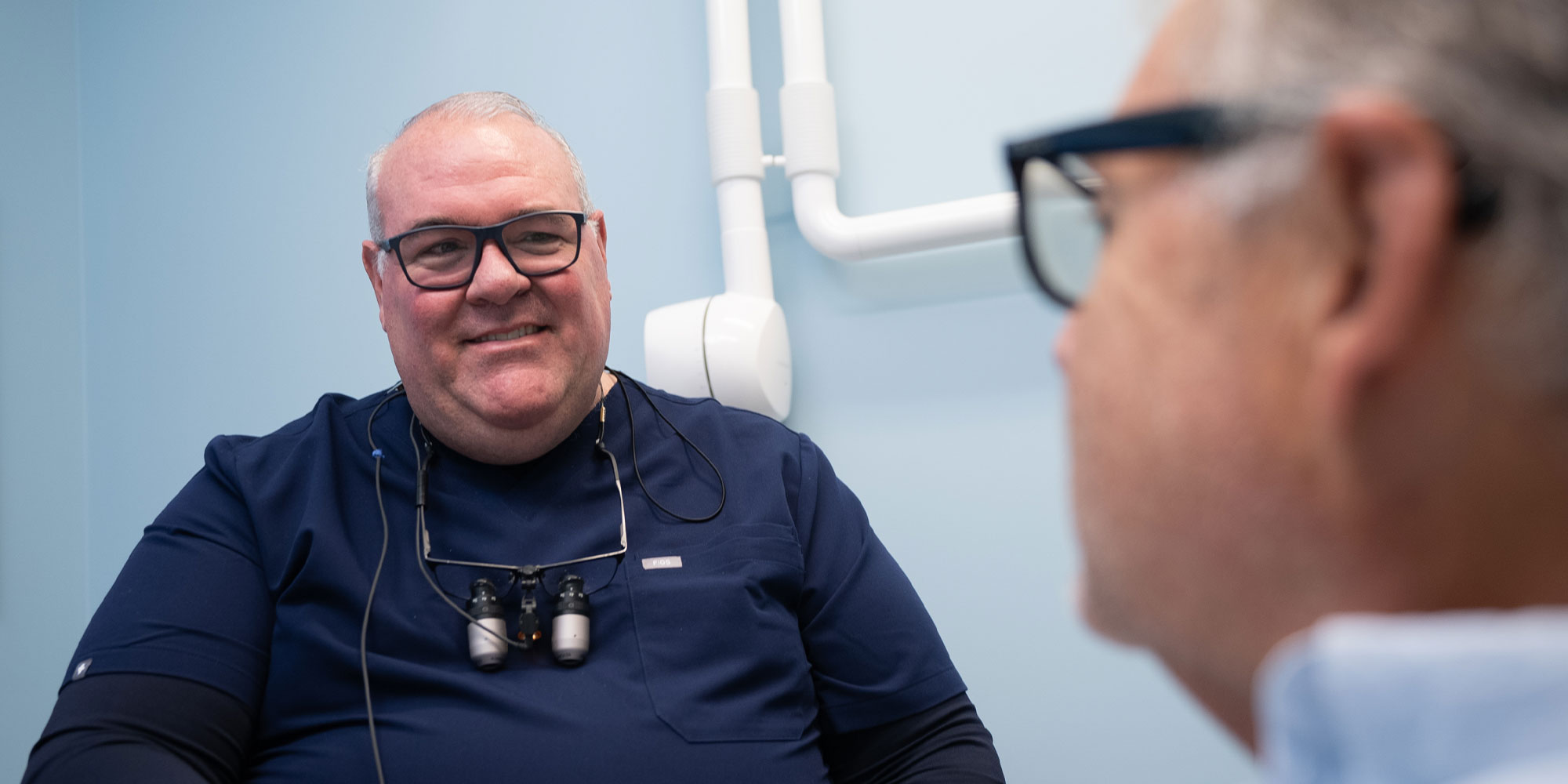 doctor going over dental treatment information with patient