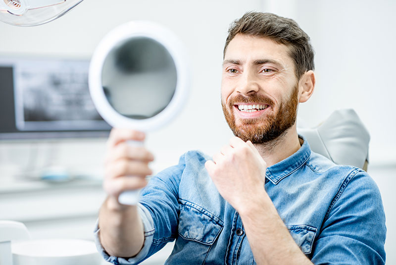 patient smiling brightly within the dental center
