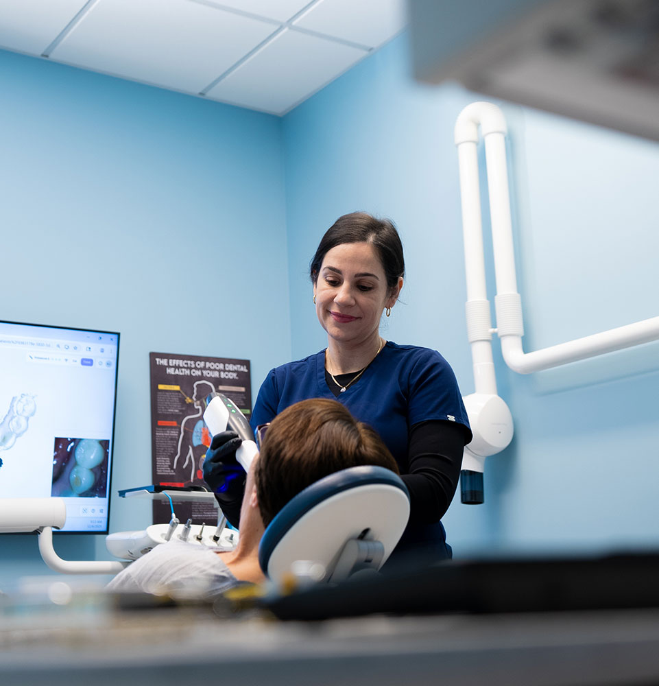 staff member examining dental patient