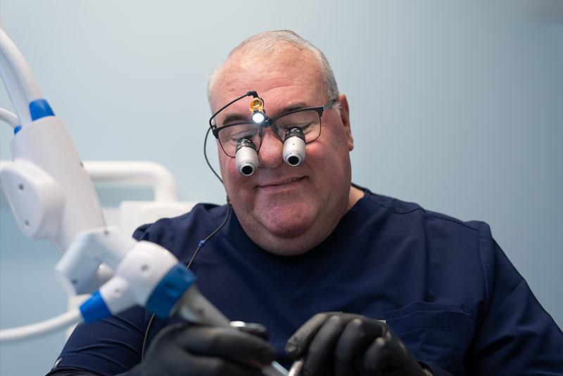 doctor performing treatment on dental patient