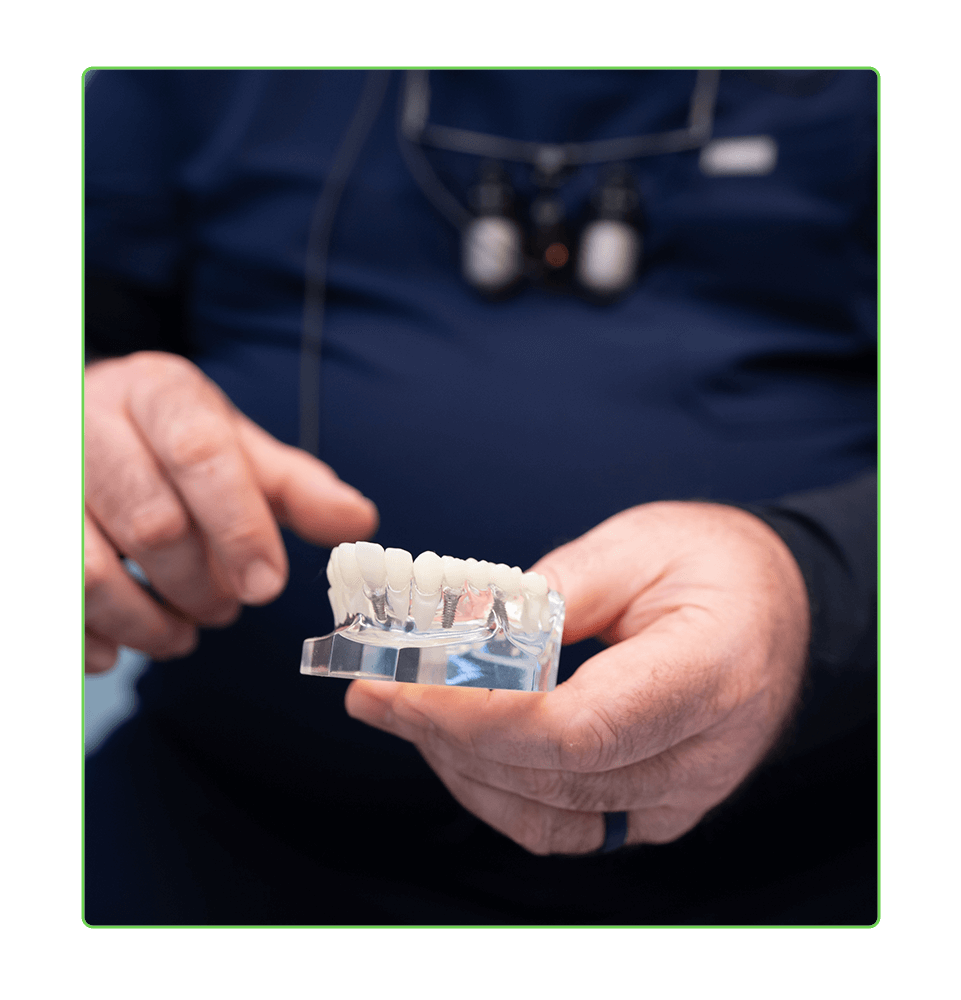 close up of doctor showcasing a full arch model