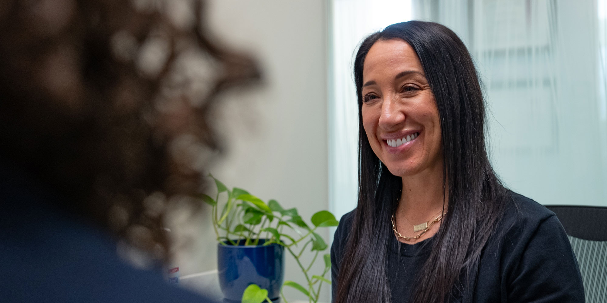 staff member helping p[patient at the front desk of the dental center
