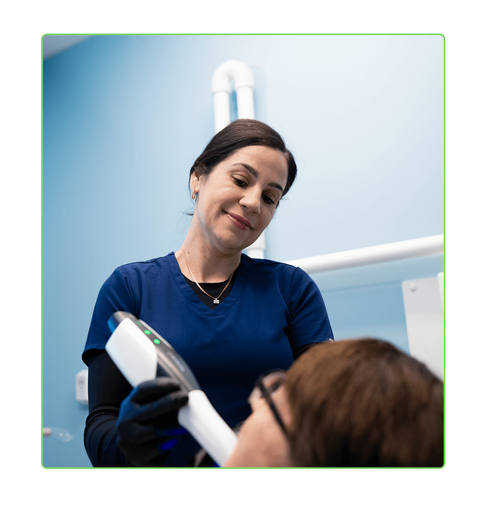 staff member performing dental examination on patient for treatment