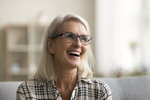 Dentist explaining crowns vs. veneers to a patient in a dental office